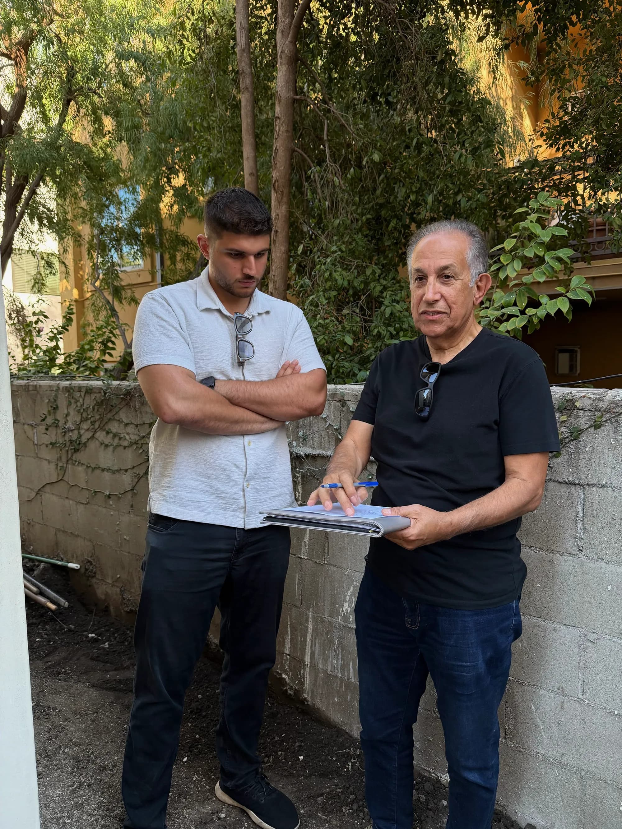 UBIC team reviewing architectural plans during a custom home planning session in Los Angeles